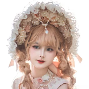 Pink classic Lolita bonnet with veil, lace trim, decorative flowers and adjustable chin tie - frontal close-up worn on model featuring elaborate headdress design