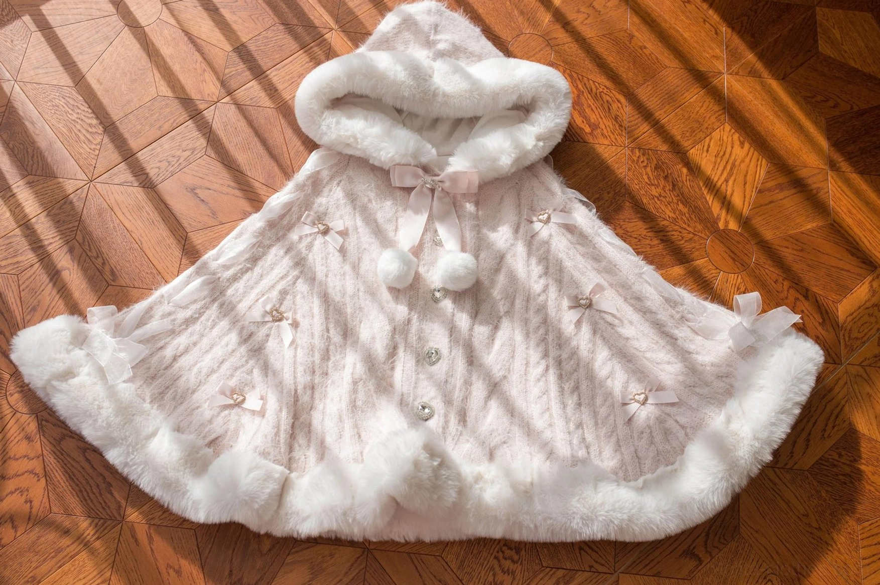 Pink lolita winter cape coat variant displayed on model with coordinated pink accessories and vintage-inspired styling for sweet lolita fashion