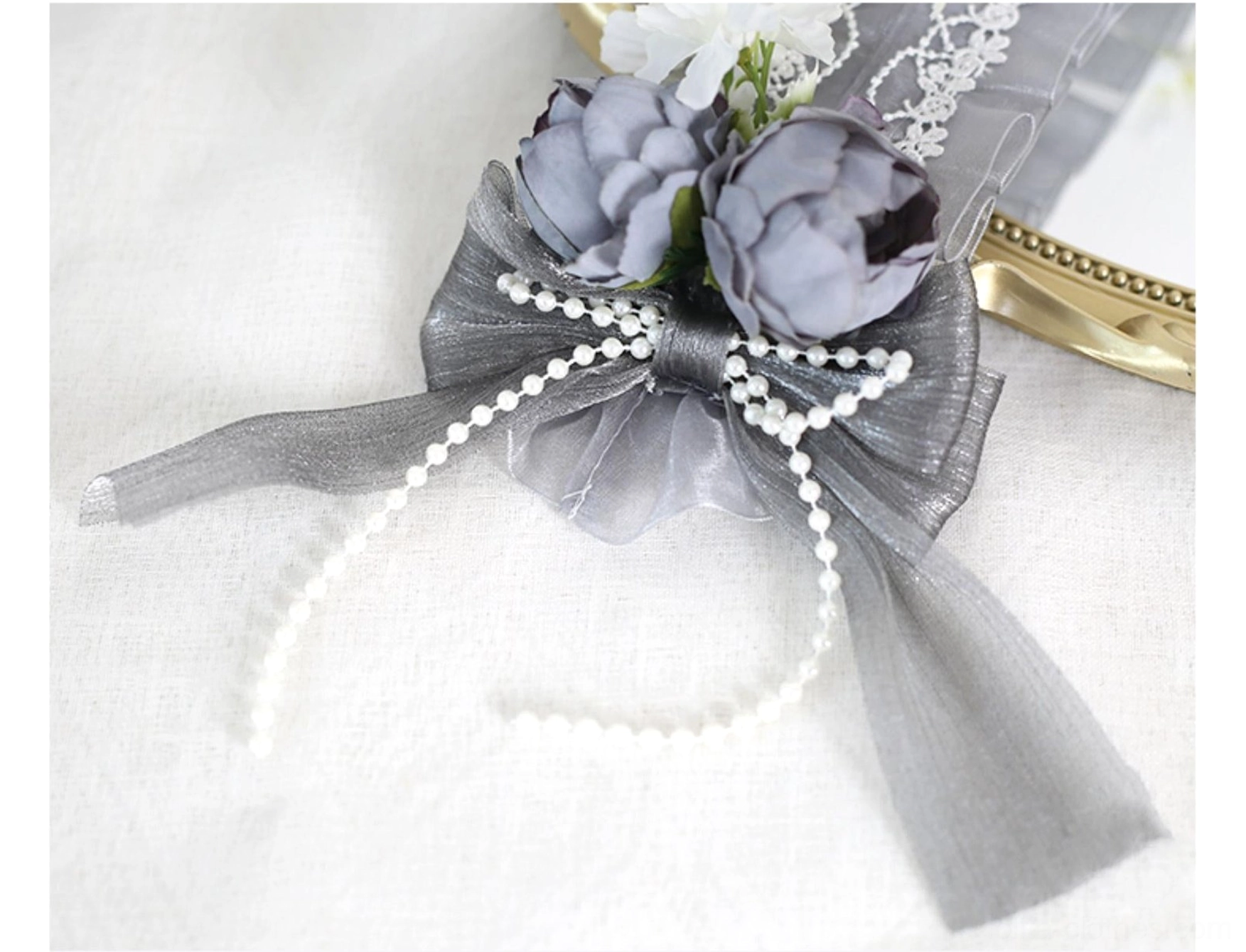 Pink lolita headband with fluffy rabbit ears and pink flower clusters on mannequin displaying pearl pendant accents