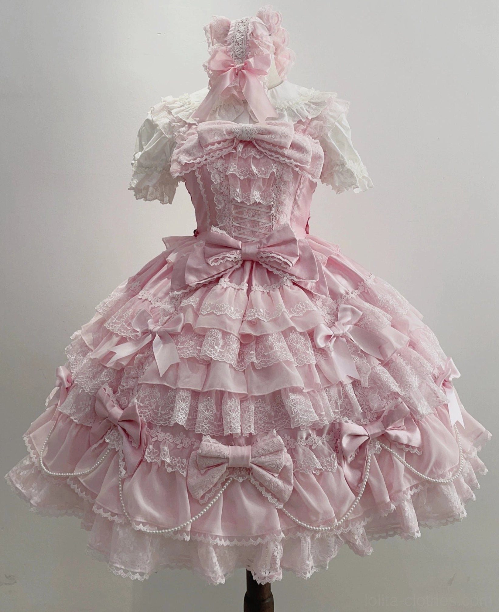 Pink lolita jumper dress alone color option showing romantic sweet aesthetic tiered skirt and flutter sleeve details