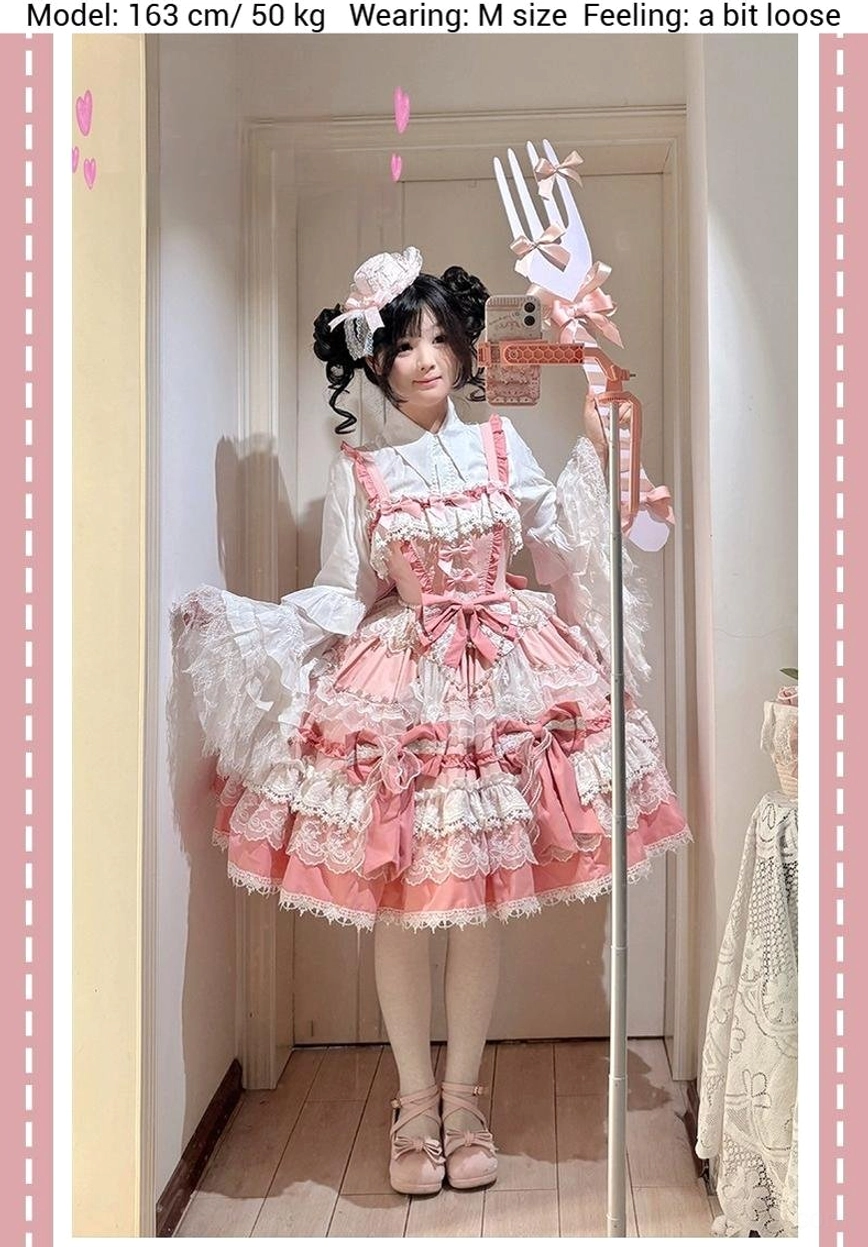 Pink sweet lolita jumper dress detail shot showing intricate lace construction, ruffled trim layers, bow embellishments, and polyester fabric texture closeup