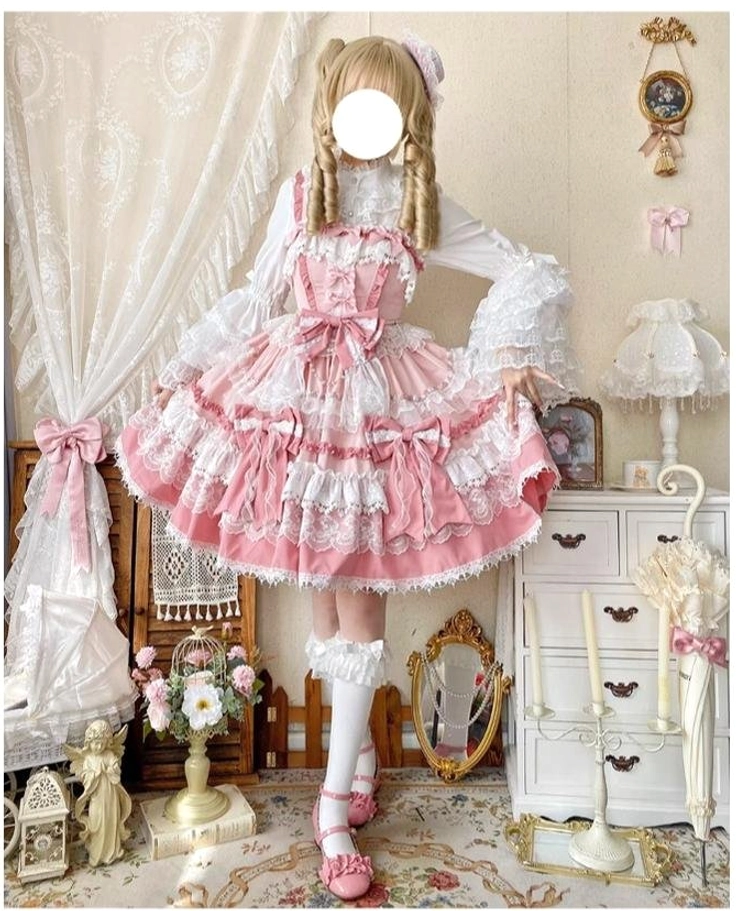 Blonde model wearing pink sweet lolita jumper dress with ruffled square neckline, multi-layered skirt, white lace stockings and pink Mary Jane shoes in vintage room