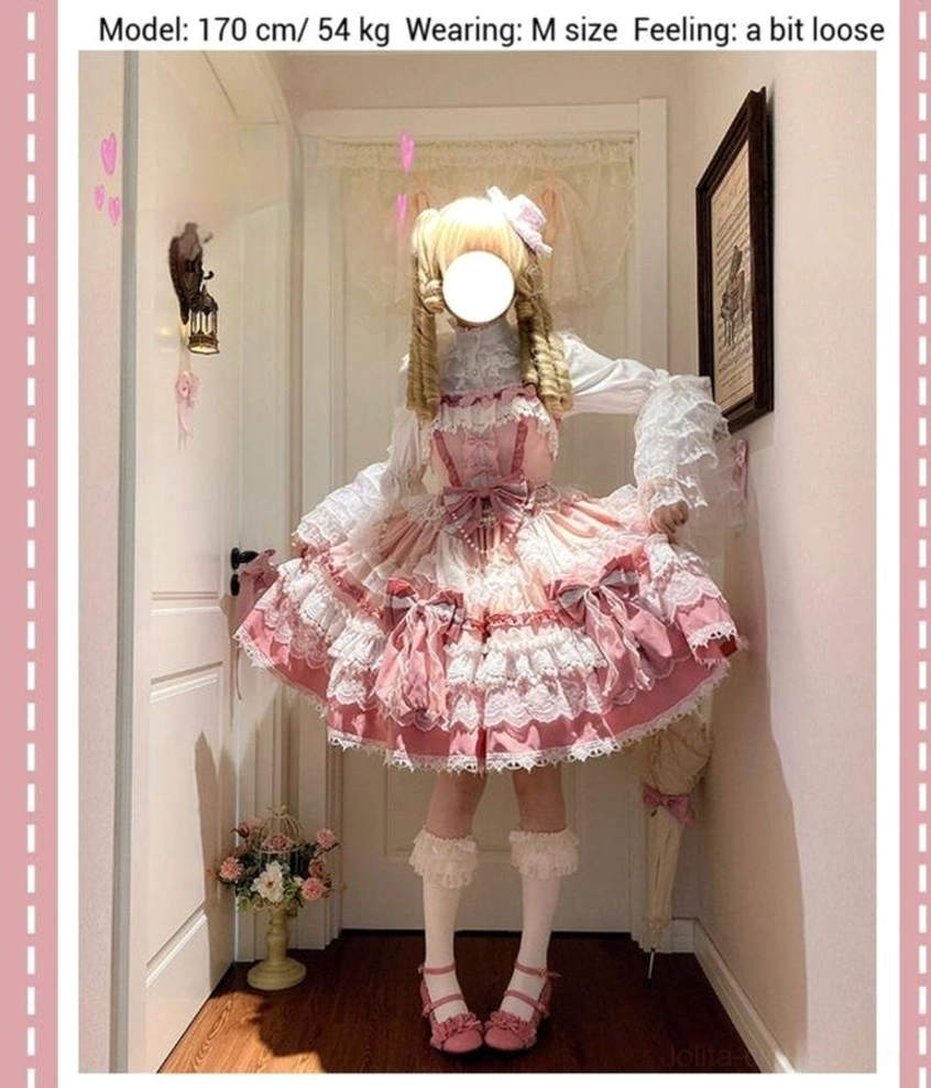 Full-body front view of pink sweet lolita JSK dress on 170cm model wearing M size with matching white ruffled stockings and pink shoes in indoor hallway setting