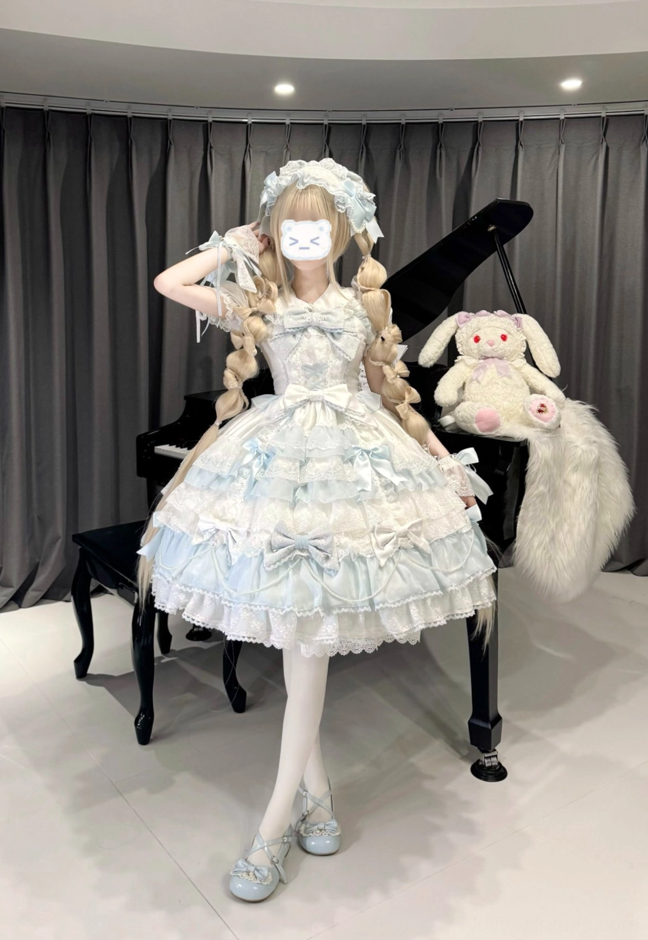 Pink lolita jumper dress hanging display showing romantic silhouette tiered skirt and decorative bow placement details