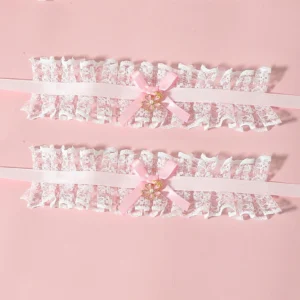 Pink lolita lace bow bracelet pair with heart metal charm and white ruffled lace, pink satin bow and strap on pink studio background
