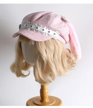Kawaii lolita pink newsboy cap side angle showing white ruffled rivet strap detail and fluffy rabbit ear design mannequin styling
