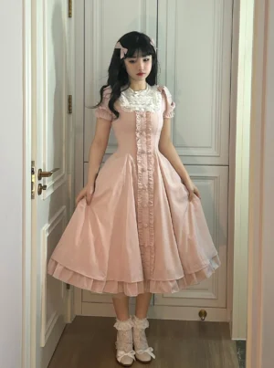 Pink lolita one-piece dress side mirror view showing ruffled skirt hem and white lace socks styling