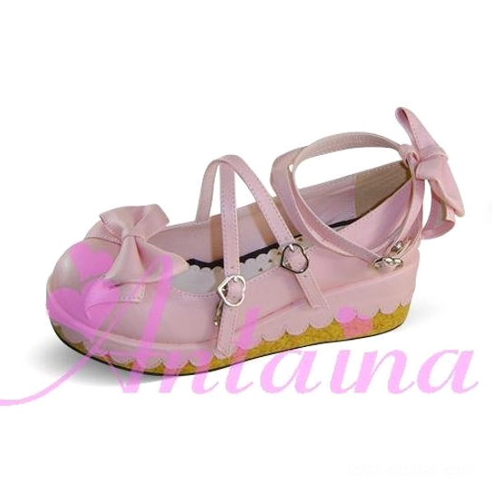 Light pink Lolita platform shoes back three-quarter view showing toe bow, cross ankle straps with heart buckles, and scalloped platform sole edge design detail