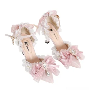 Soft pink lolita pointed-toe heels featuring embroidered butterfly motifs and pearl decorations on white minimalist background, angled overhead view displaying branded leather insole and decorative bows