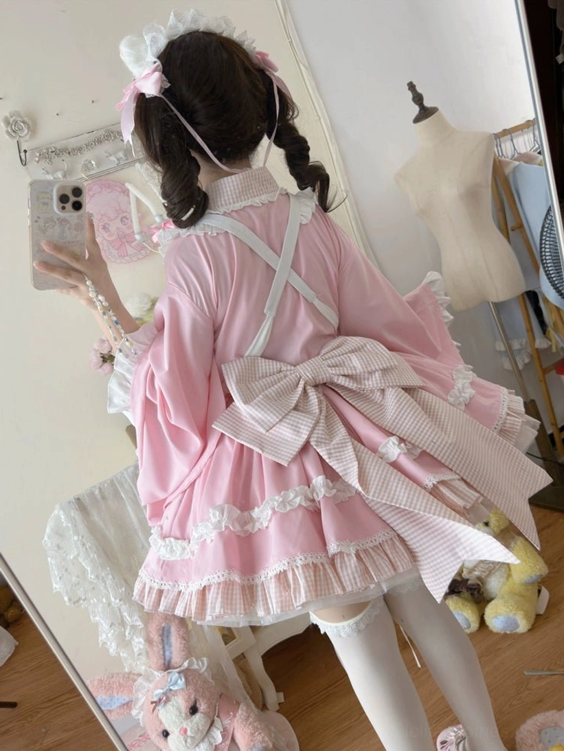 Pink maid lolita nurse dress set back full-body view with twin curly buns hairstyle showing oversized bowknot and cross back straps