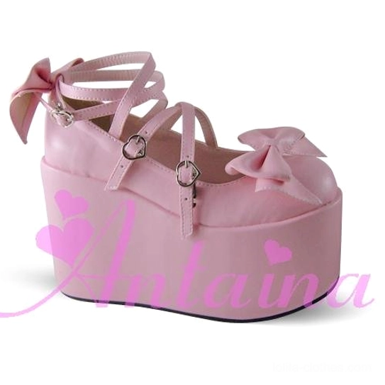 Light pink Lolita platform shoes back three-quarter side angle showcasing toe cap bow decoration, cross ankle straps with heart buckles, and large wedge platform foundation
