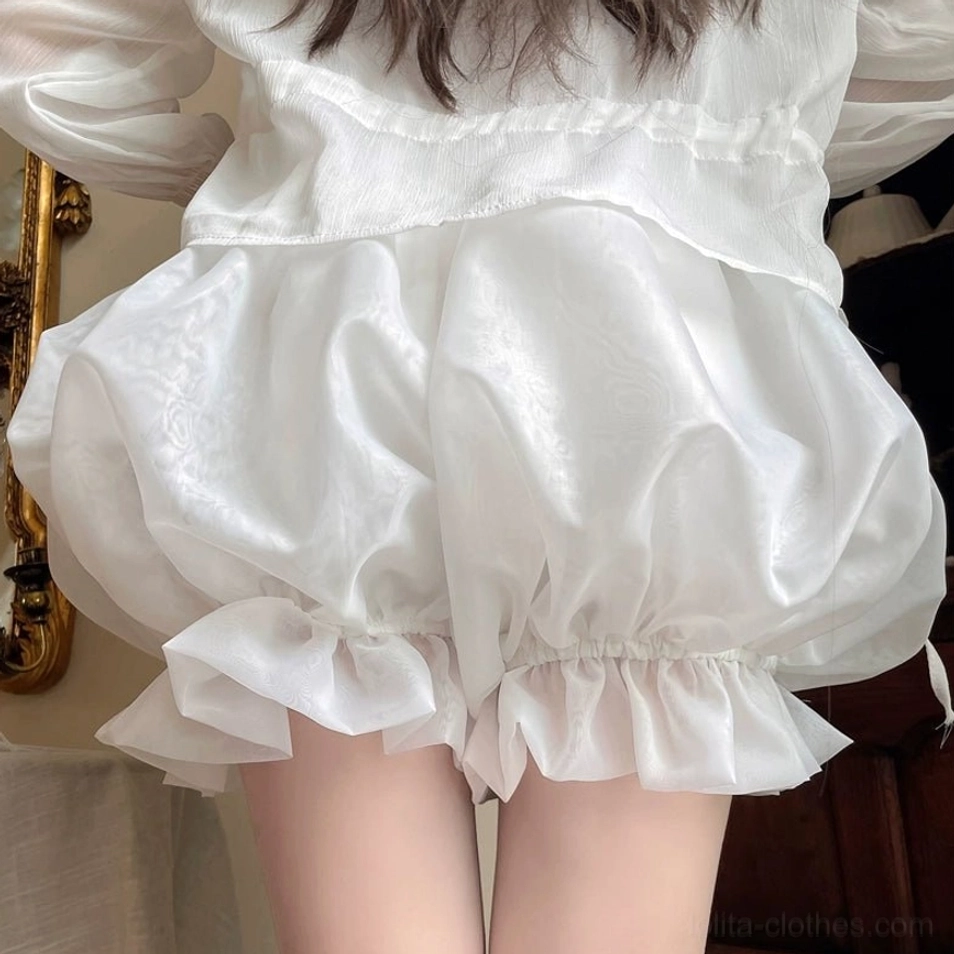 Pink solid color organza lolita bloomers front view showing elasticated waistband with decorative satin bow ruffled hem and puffy silhouette