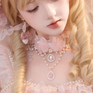 Lolita bridal pearl necklace and earrings set featuring dual-layer pearl chains with pink teardrop gemstone pendant and pearl heart studs, close-up detail view