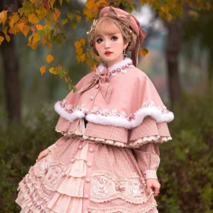 Close-up half-body front view of pink plaid lolita blouse with peter pan collar and cute bow accents fluffy fur trim details
