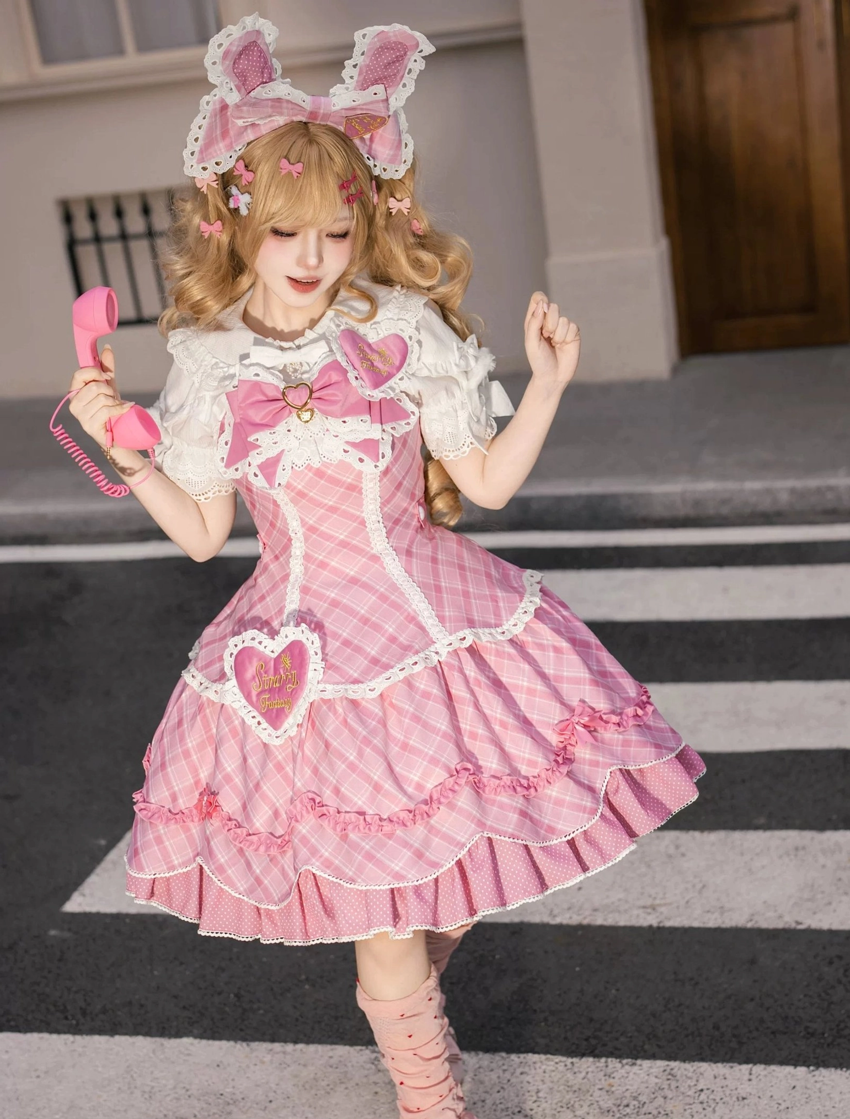 Pink plaid sweet lolita JSK jumper skirt dress full-body modeling view in 2XL size showing gingham construction detachable collar bow heart patch and multi-layer ruffled lace hem trim for sweet lolita aesthetic