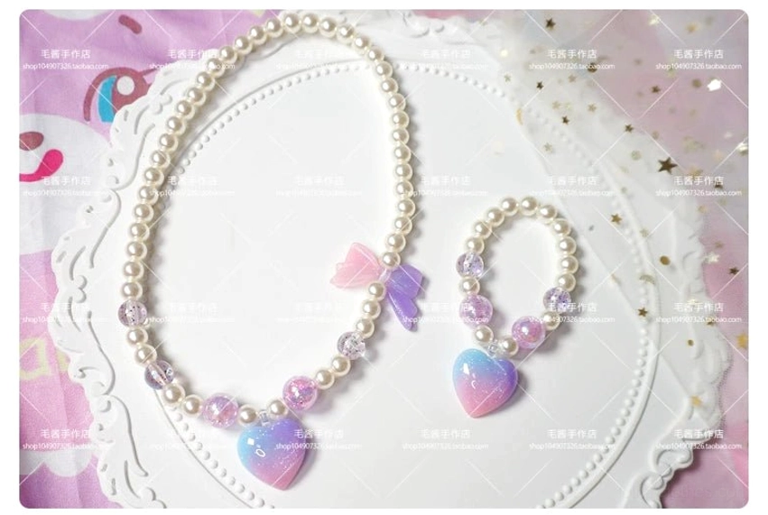 Single pink purple ombre heart charm pearl choker and beaded bracelet lolita jewelry set flat lay