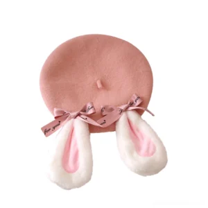 Flat lay front view of pink rabbit ear Lolita beret displaying standard round beret silhouette, fluffy rabbit ears, and pink satin bow against pure white background