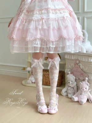 Pink rose jacquard mid-calf lolita bow socks with light pink satin bows worn on model in doll-themed bedroom setting paired with pink mary jane shoes