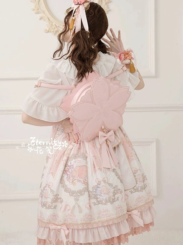 Back full view of pink sakura cherry blossom lolita backpack bag with matching petal design ruffled dress coordinate