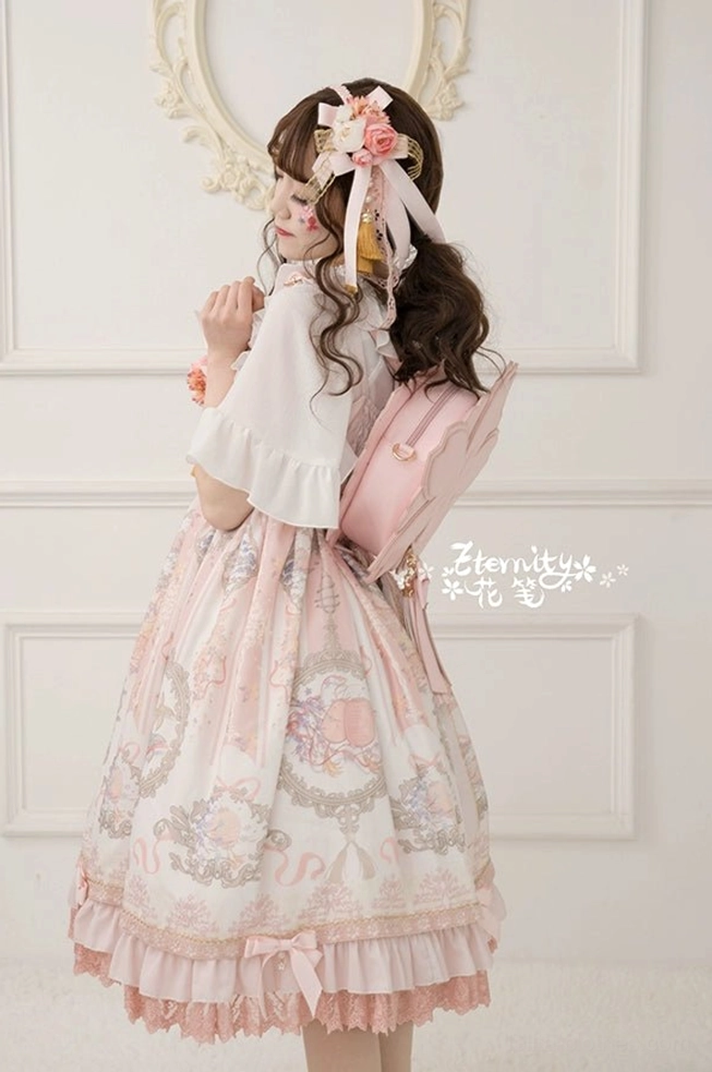 Back view of pink sakura lolita crossbody bag backpack style with ruffled dress hem vintage pattern print