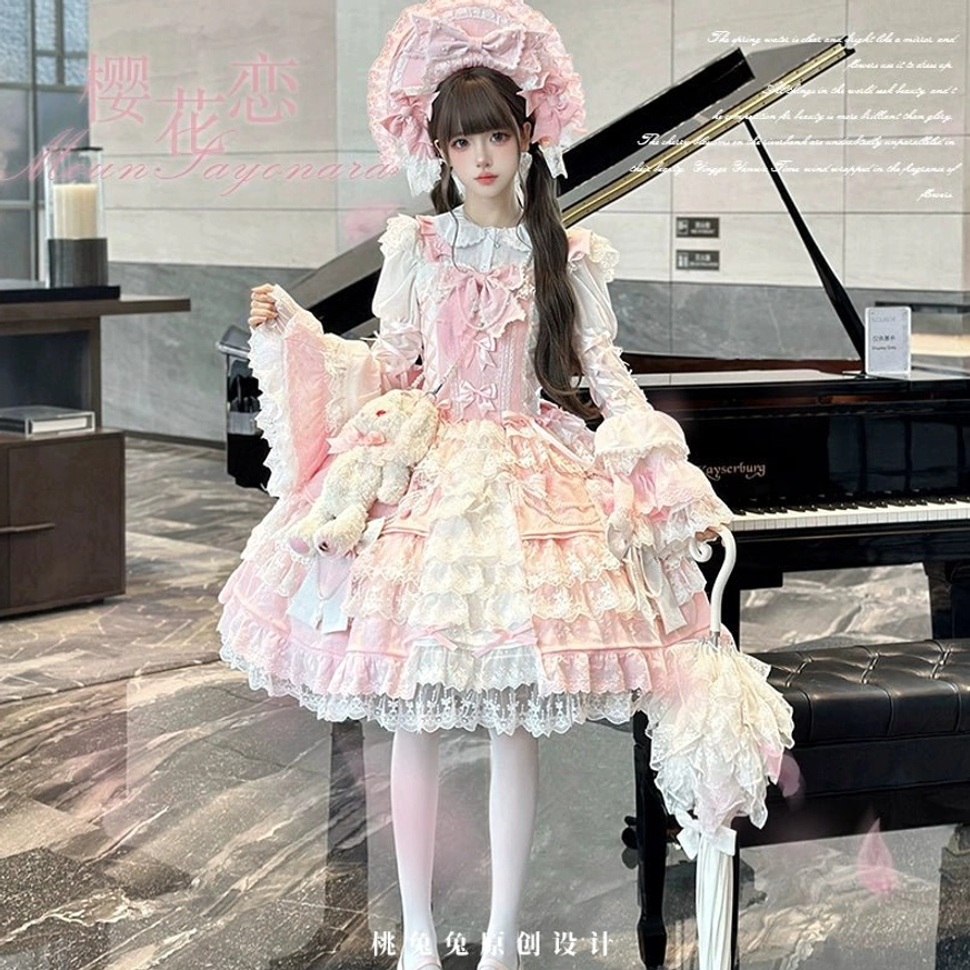 Pink Sakura Love lolita dress suit front three-quarter full body view featuring pink-white layered ruffle skirt, big bow bonnet, flared lace sleeves, front bow decorations, plush rabbit bag charm