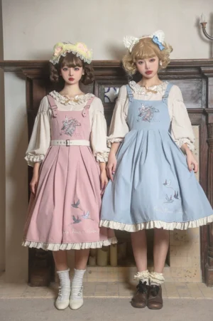 Pink and sky-blue bird embroidery Lolita JSK dresses with inner blouses dual model display front standing view indoor retro wooden doorway background coordinated aesthetic