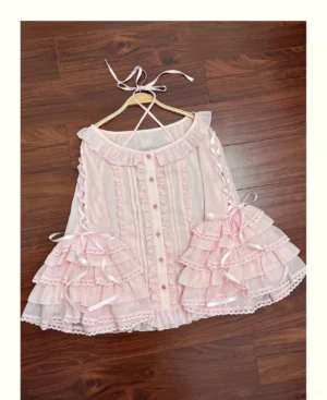 Pink halter-neck sweet lolita blouse with layered ruffles and satin ribbon bows, featuring trumpet hime sleeves and delicate lace trim on wooden background