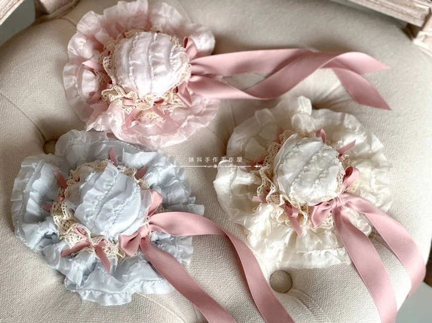 Pink small bowler hat lolita headdress with delicate ruffles bow details and long flowing satin ribbon tail