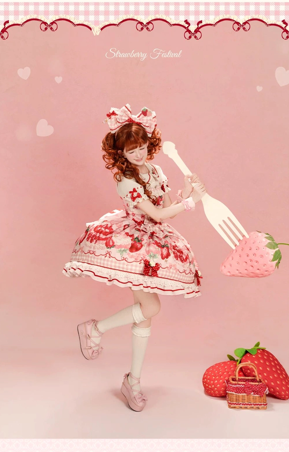 Pink strawberry Lolita JSK dress full-body jumping pose Peter Pan collar ruffled hem matching bow heart backdrop aesthetic