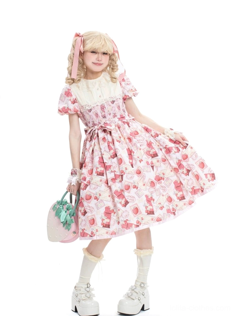Pink strawberry Lolita one-piece dress three-quarter side view displaying waist bow detail, shirred bodice, flowy midi skirt with all-over prints, model carrying mini handbag props with pink bows