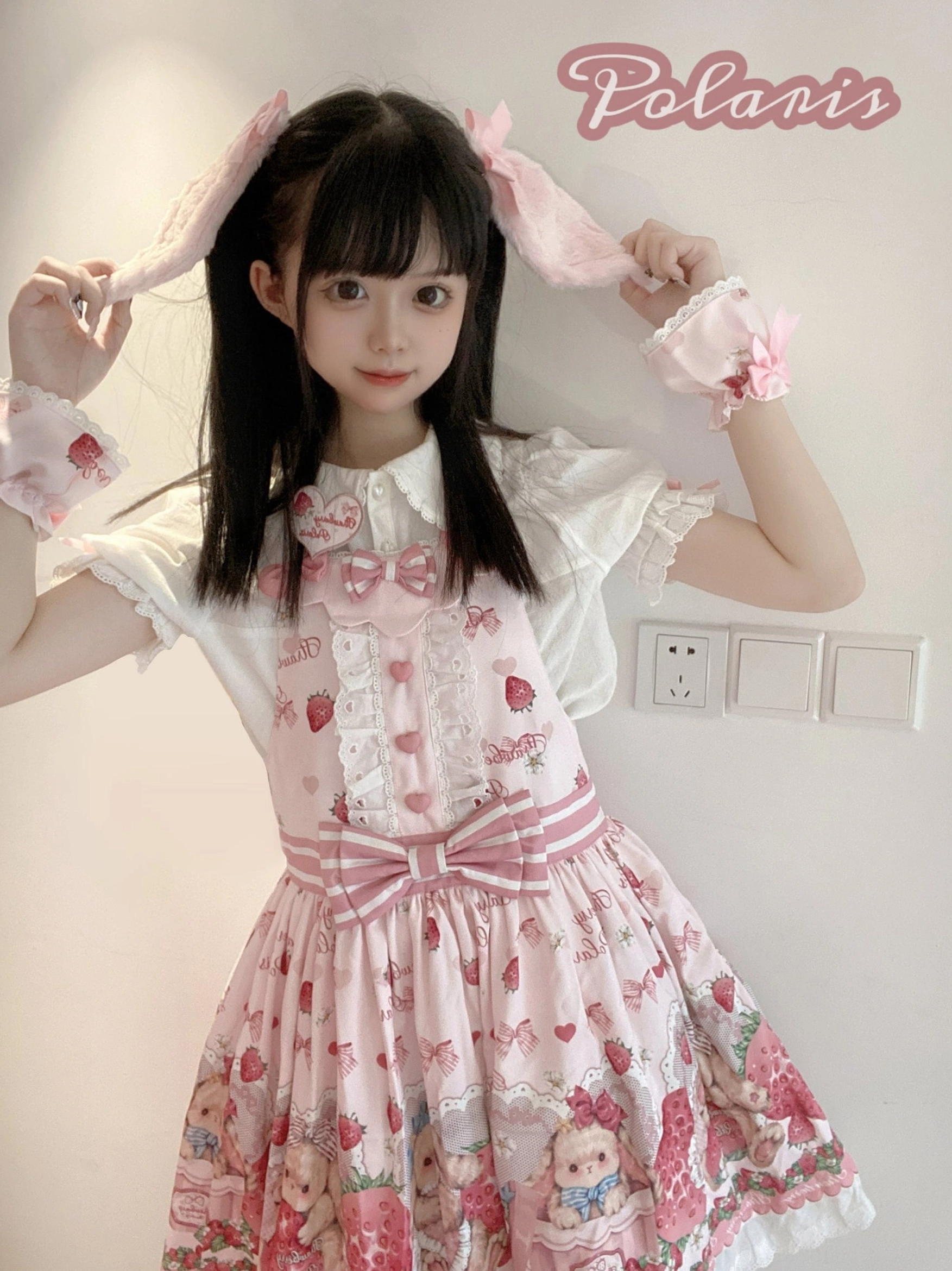 Pink strawberry sweet lolita salopette dress worn on model from back view showing adjustable straps and waist details
