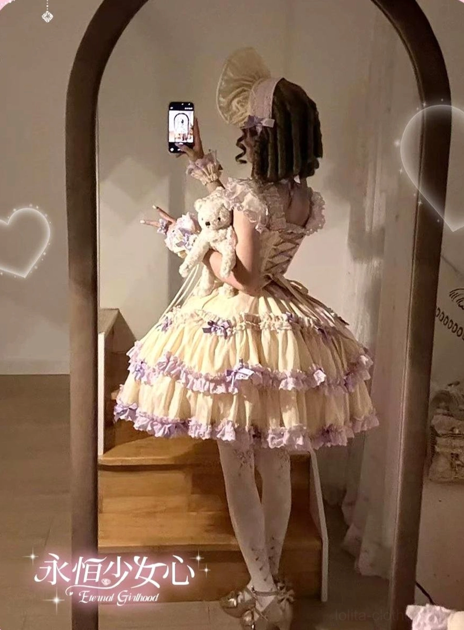 Pink striped classic old school Lolita jumper skirt side view showing silhouette, ruffled layers, and bow placement details