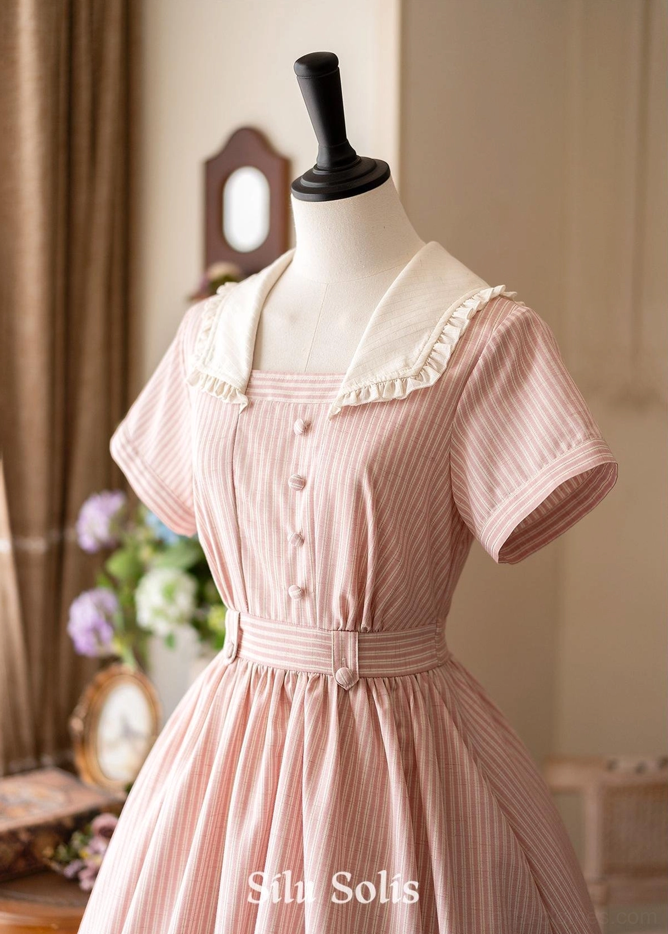 Close-up partial front view of pink striped Lolita OP dress highlighting ruffled white sailor collar, front button placket, high waist belt, and short sleeves