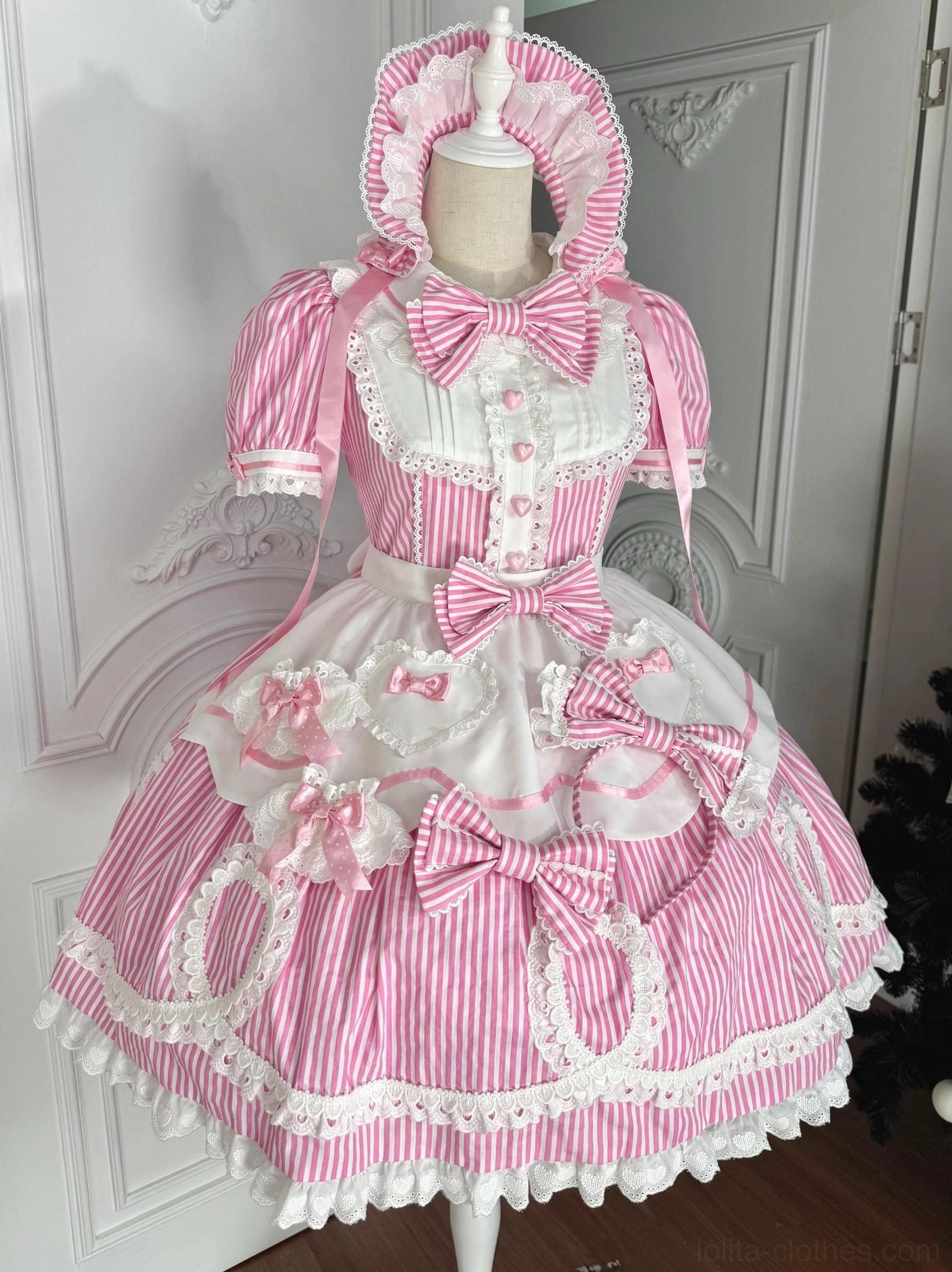 Pink vertical striped old school lolita OP dress with detachable apron and matching bonnet displayed on dress form front view
