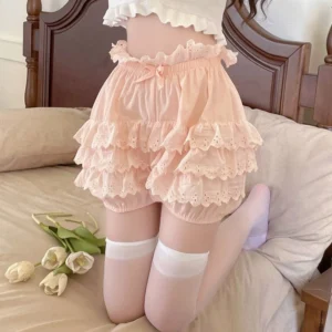 Light pink sweet Lolita tiered lace bloomer shorts with ruffled elastic waist and scalloped embroidered lace cake hem, front overhead close-up shot