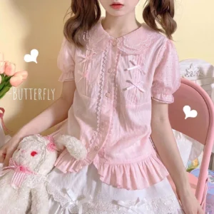 Pink sweet Lolita short-sleeve blouse with lace-trimmed Peter Pan collar and chest bow decorations indoor portrait closeup