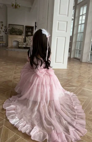 Pink sweet lolita high-low dress back view showing long flowing tulle train with satin ruffled trim and large back bow decoration