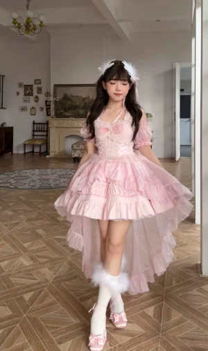 Pink sweet lolita high-low party dress with puff short sleeves and ruffled layered tulle hem worn with fluffy leg warmers and hair accessories