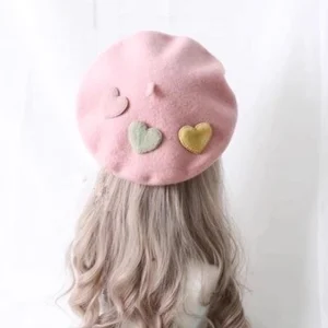 Pink sweet lolita wool beret with removable pastel heart brooches worn on curly blonde wig, back top view showing soft fuzzy wool texture and delicate heart appliques
