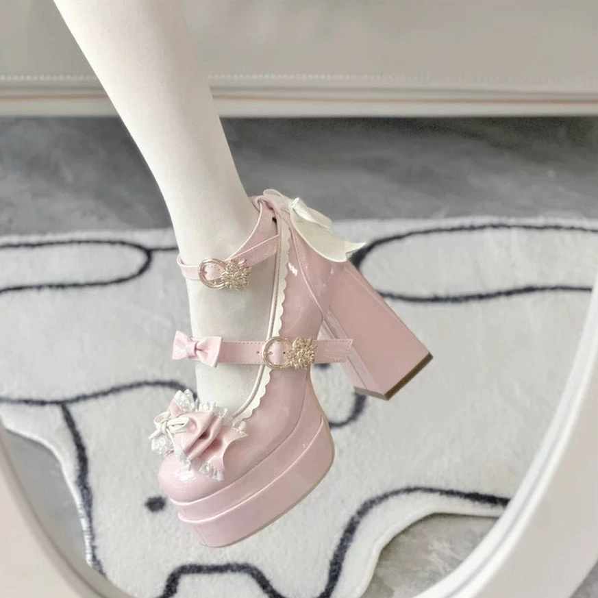 Pink sweet Lolita platform heels on-foot side view detail with ruffled bow and gold heart buckle ankle strap decoration