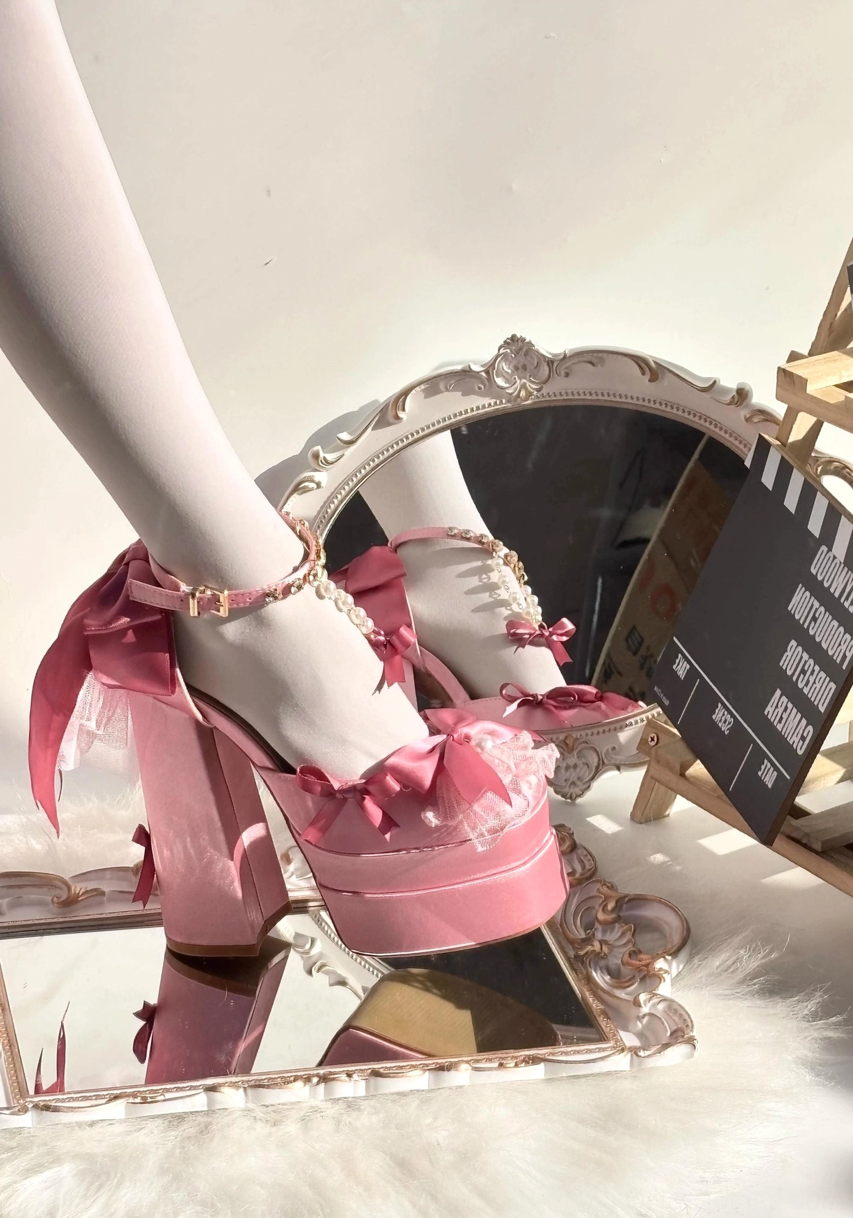 Pink sweet lolita high heel platform shoes with pearl rhinestone ankle chains and lace tulle trims, studio close-up vintage vanity mirror display