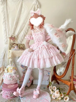 Pink Sweet Lolita JSK dress full front body view on cosplay model in vintage girly bedroom with off-shoulder ruffled sleeves tiered lace hem and large waist bow matching hair accessories