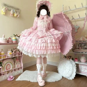 Pink enchanted bride sweet lolita JSK dress with multi-layered ruffled lace skirt and matching parasol, full-body front view worn by model in vintage candy shop studio setting