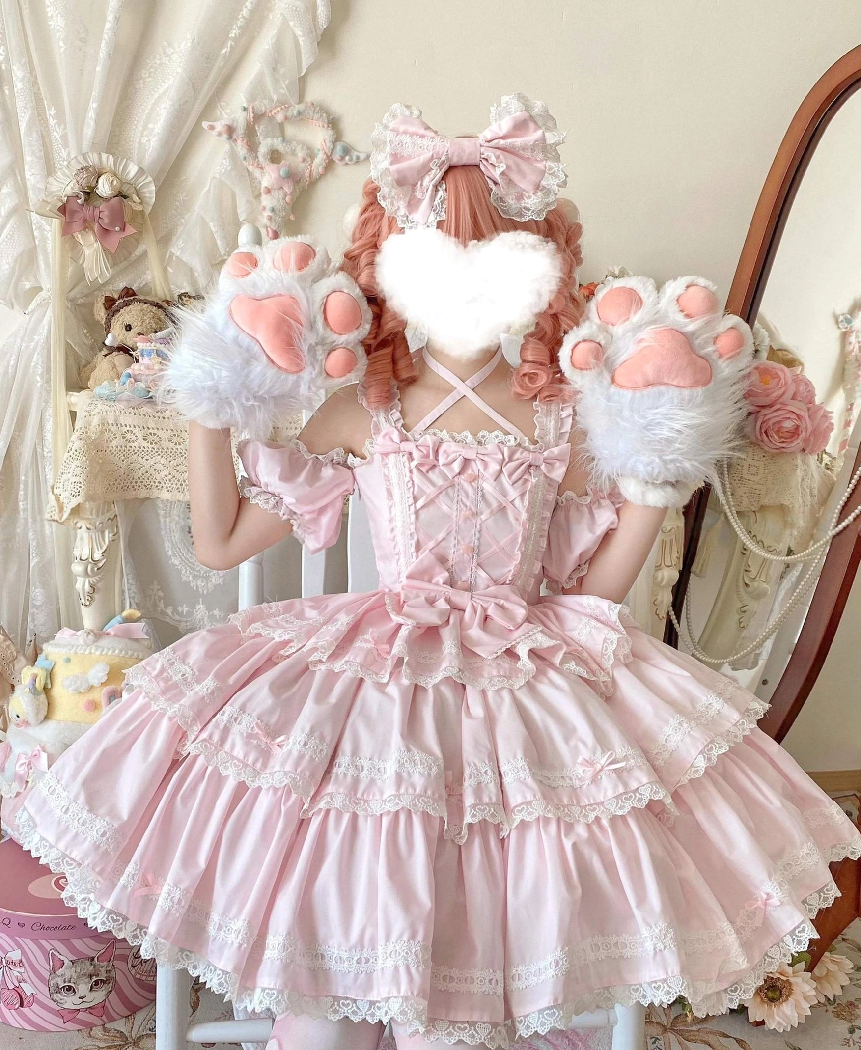 Pink Sweet Lolita JSK dress seated model cat paw plush props matching hair bow lace-trimmed tiered skirt crisscross bodice front waist bow