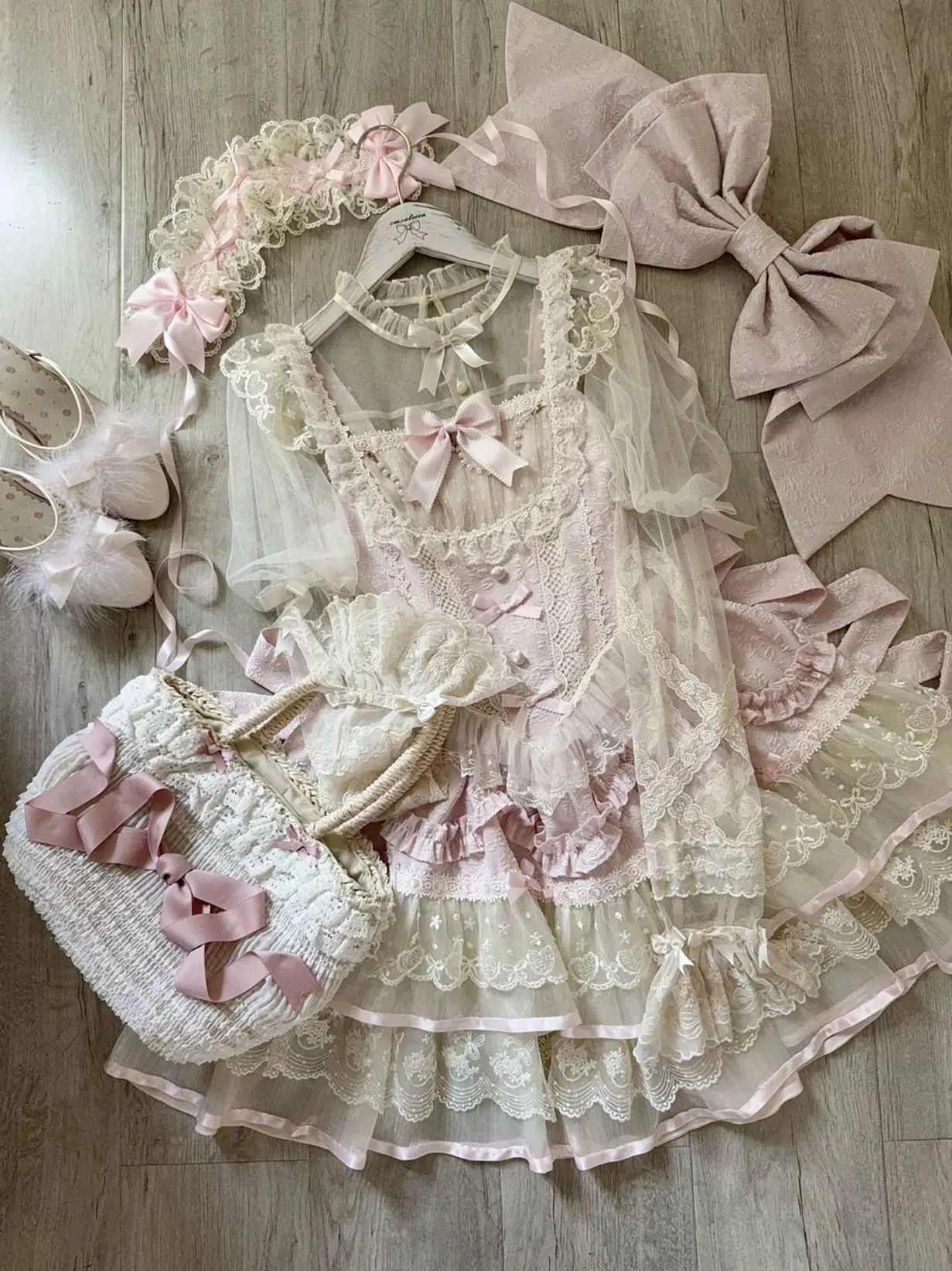 Pink sweet lolita JSK dress variant featuring pink petal-style ruffles, ivory bodice, coordinated color palette, and elegant silhouette of the lolita jumper skirt design