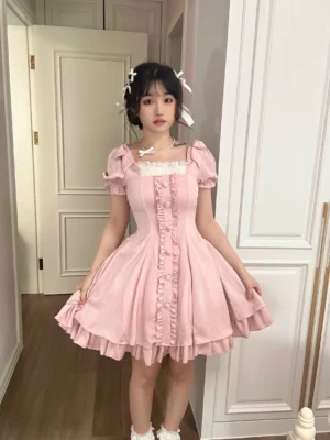 Full-length pink lolita OP dress with fitted waist flared skirt double-layer ruffled hem square neckline and white lace trim styled with white socks and shoes