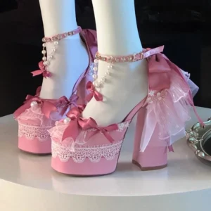Pink sweet lolita platform heels with satin bow accents and pearl ankle chain, mannequin foot overhead close-up detail view