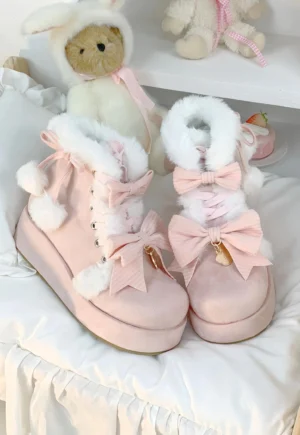 Pink creamy sweet lolita snow boots close-up with thick platform sole fuzzy fur cuff and pom-pom embellishments