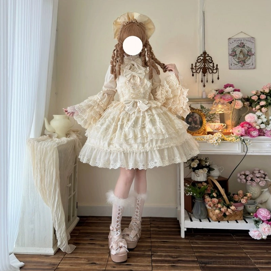 Pink sweet wedding lolita JSK dress with detachable bow close-up detail showing lace work and pearl accents