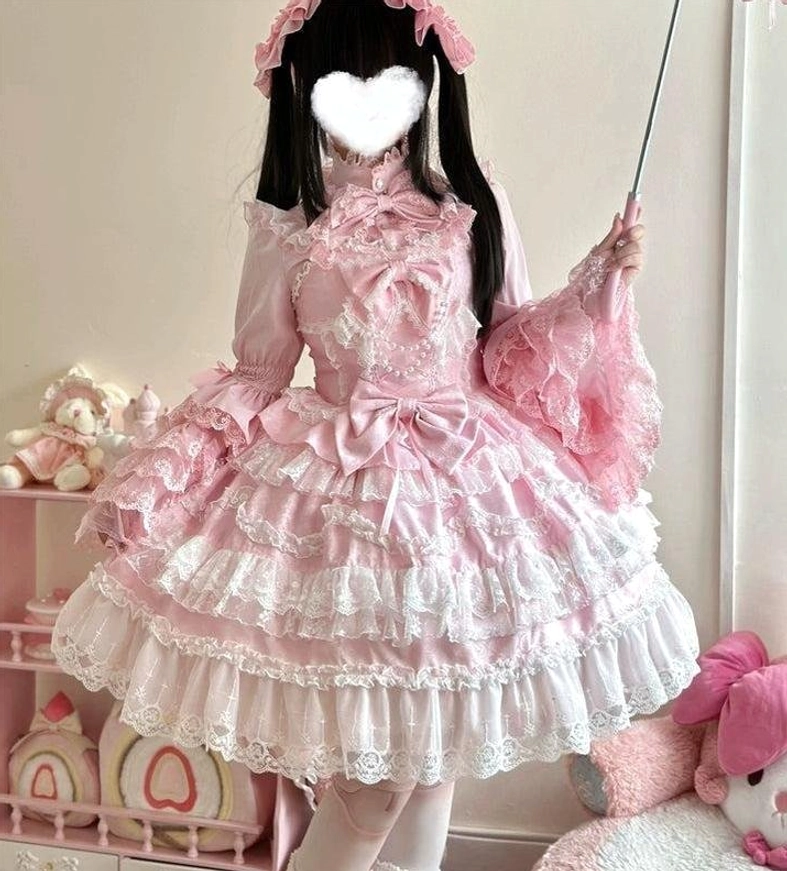Pink sweet wedding lolita JSK dress half-body side turning view with high ruffled neckline and layered lace skirt detail shot